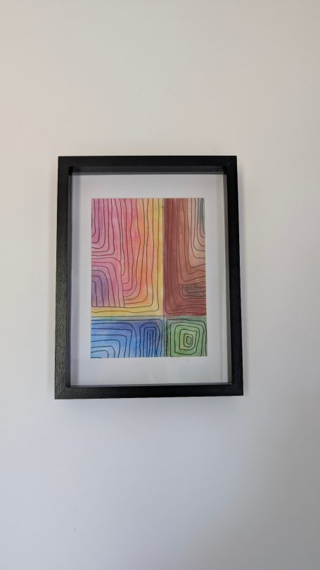 Bunte abstrakte Zeichnung in einem schwarzen Rahmen, bestehend aus geometrischen Formen.